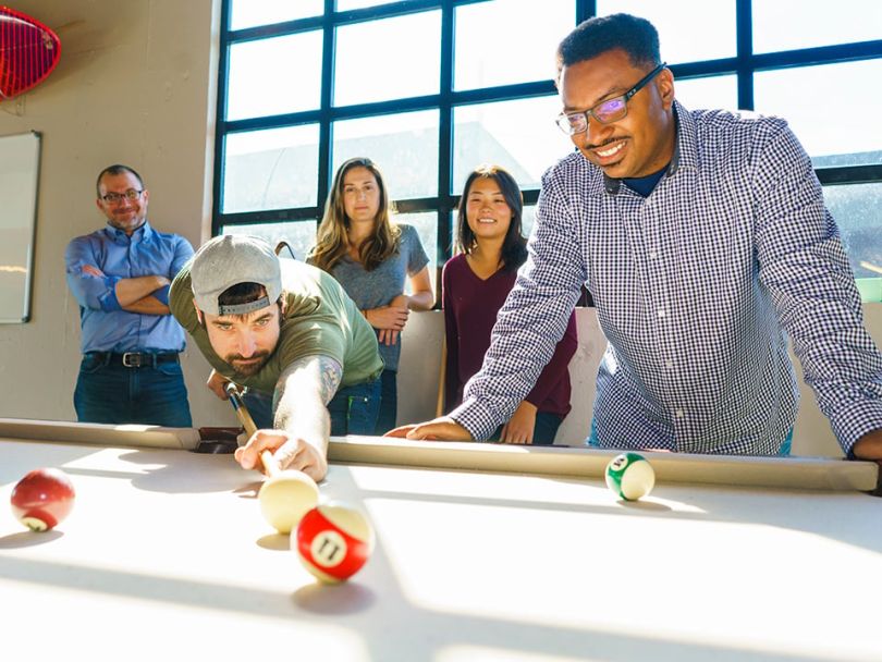 Employees play pool at SteelHouse