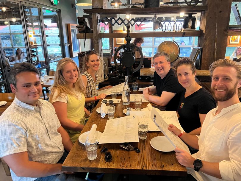 A photo of the Prove Denver team enjoying a meal together. 