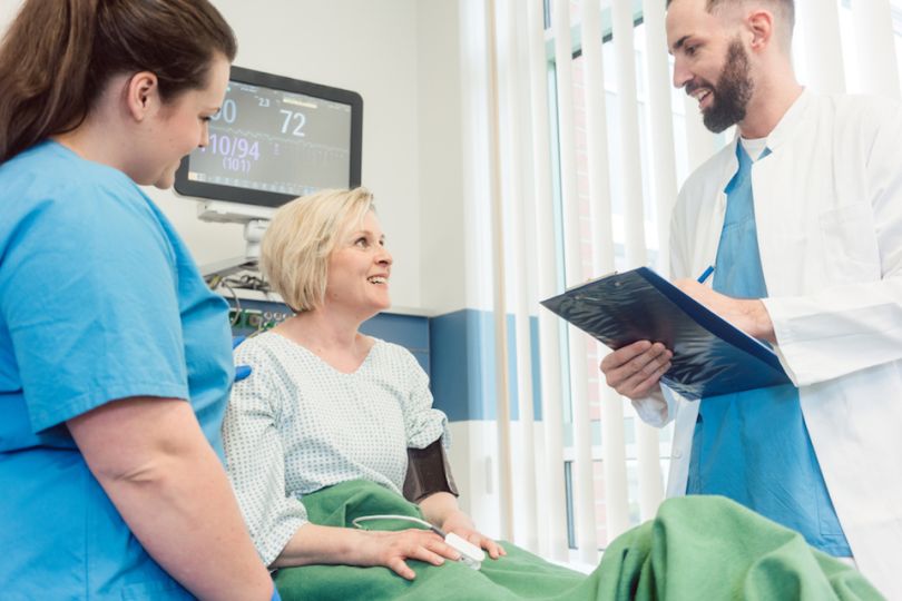 Doctors and smiling patient