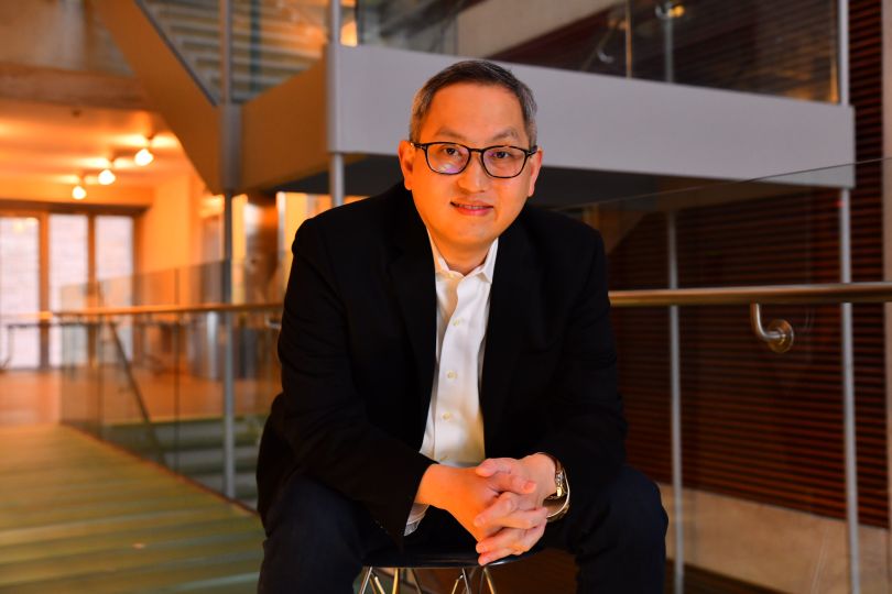 NanoGraf CEO Francis Wang sits in a chair for a photo.