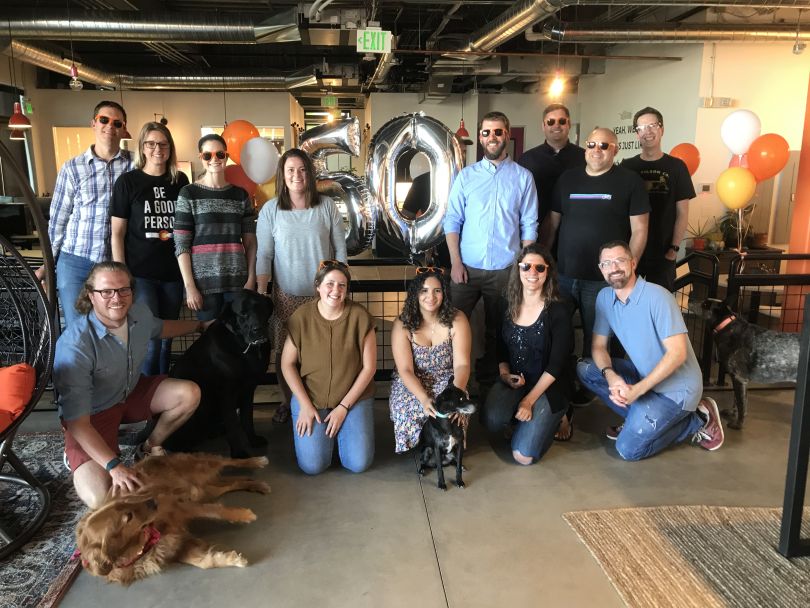 A group of Duda employees together in the office.