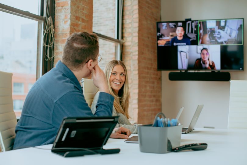 Photo of employees at LogicGate working together at a table. 