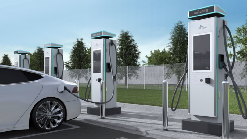 A row of PowerNode EV charging stations behind a parked vehicle.