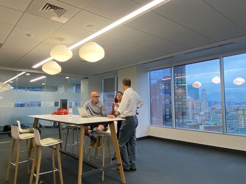 Team members having a conversation in the Ellevation Education office