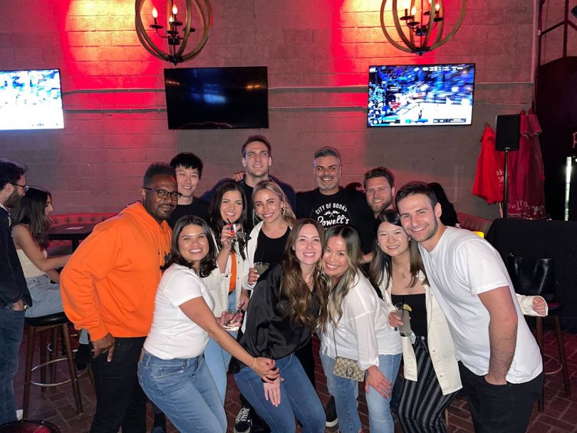 Emotive team members at a sports bar watching a basketball game
