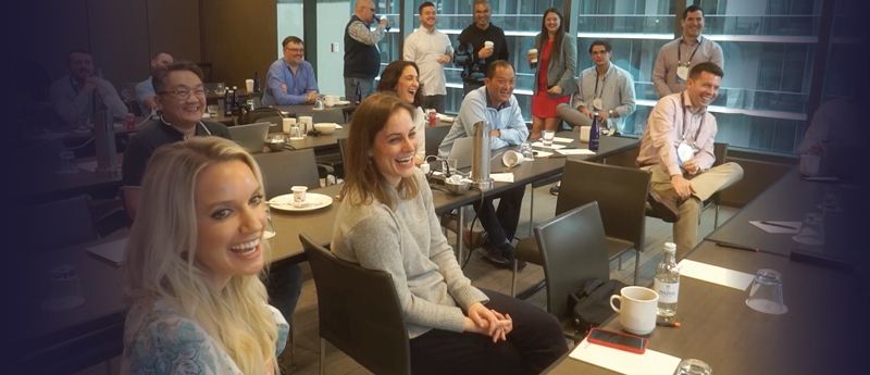 Enfusion employees sit in rows of desks at their office. 