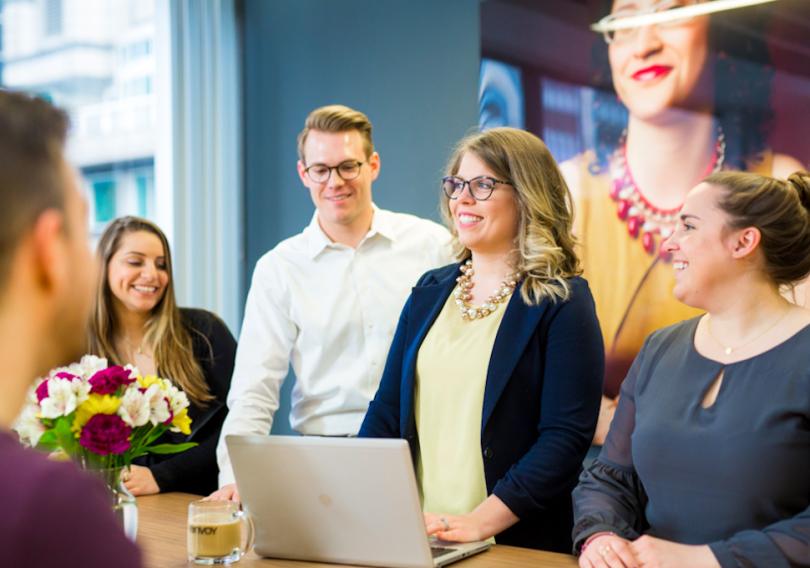 Envoy global team pictured standing at table