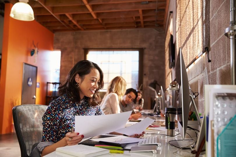 A woman working at a desk in a modern office