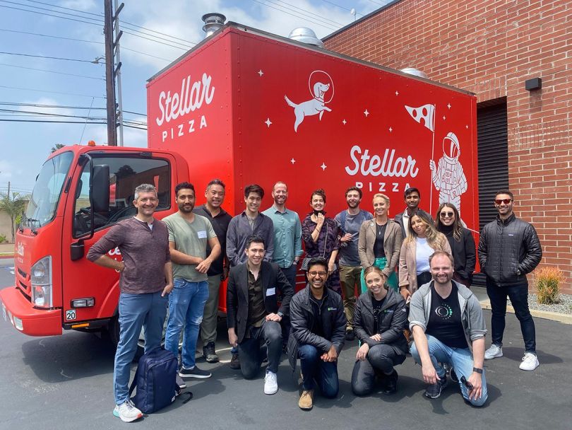 First Resonance team members standing with a Stellar Pizza truck