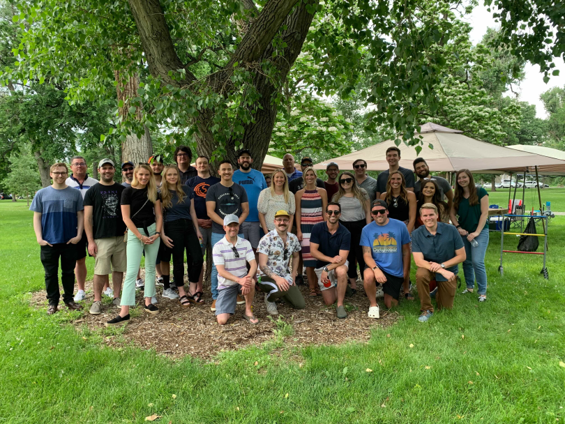 GigSmart's employees posing for a group photo outdoors.