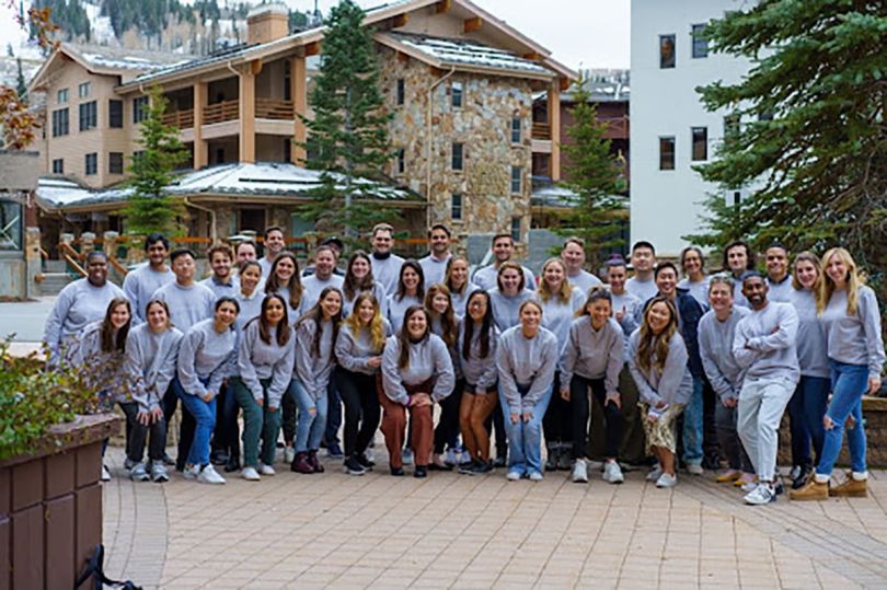 GlossGenius team members outside at a ski lodge