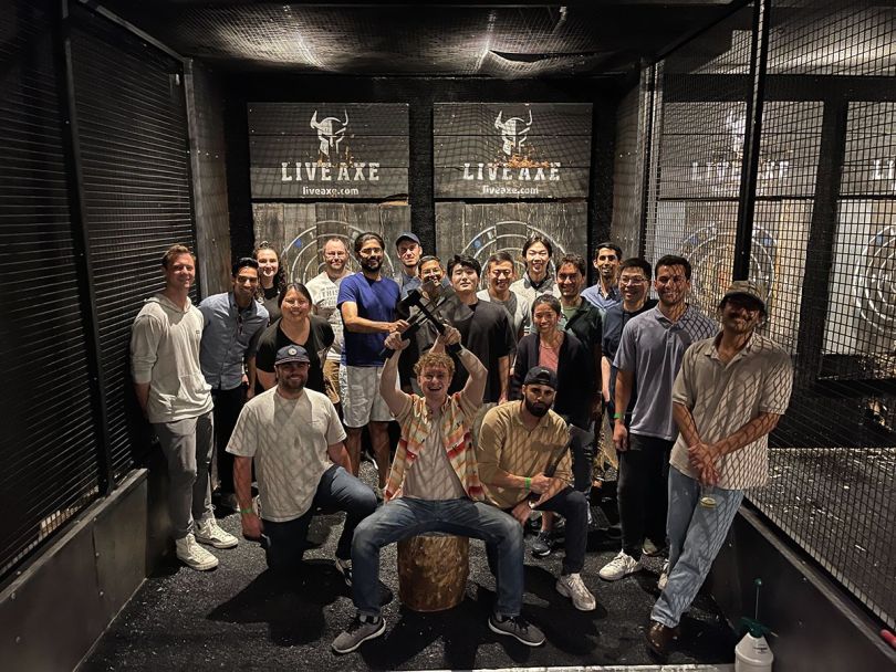 Grata team photo at an axe throwing facitility