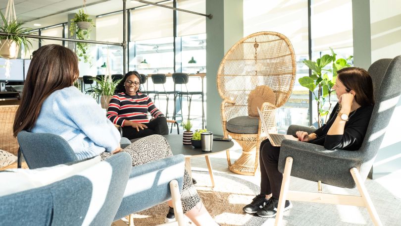 Group of workers in office casual meeting area