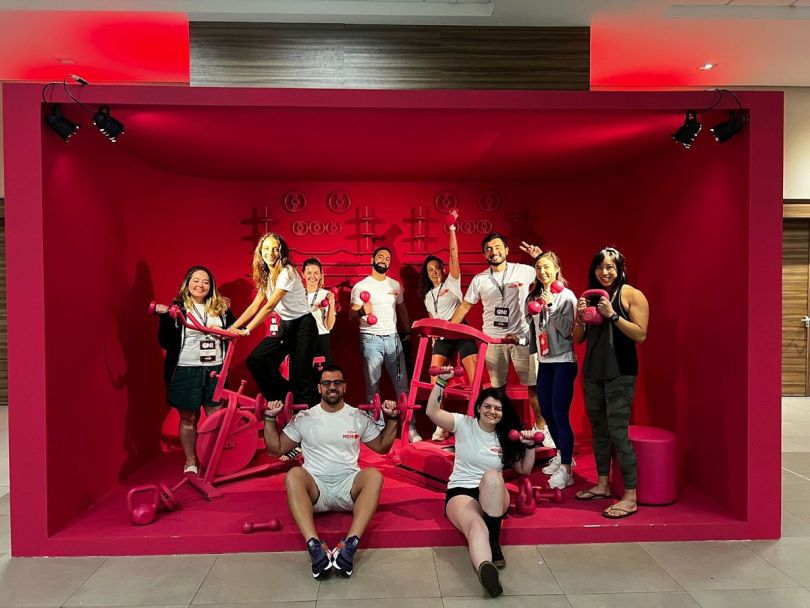 Gympass team photo with stylized gym equipment