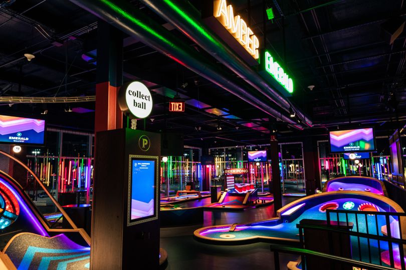 Neon lights light up the Puttshack mini golf location in Oak Brook