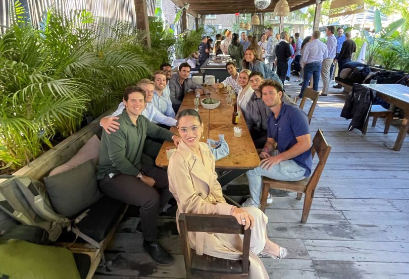 Some of Visible Alpha's employees at a table together.