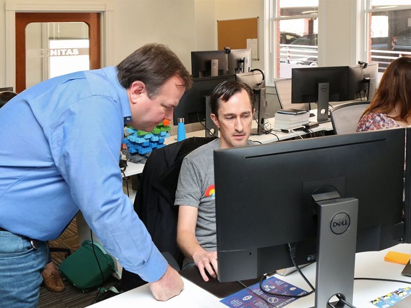 Jim Treinen speaking with employees