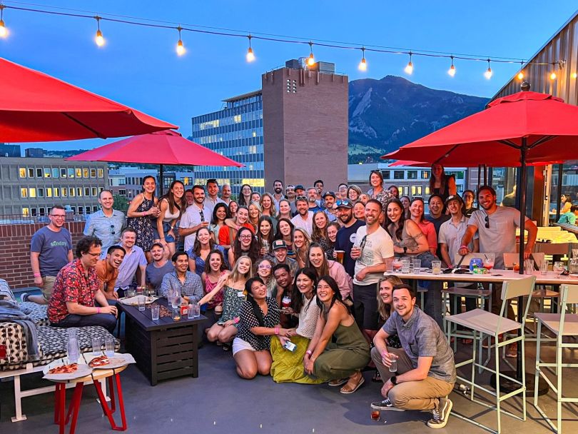 Sunday's employees posing on a rooftop patio.
