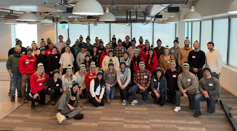 Large group photo of TextUs team members in their office