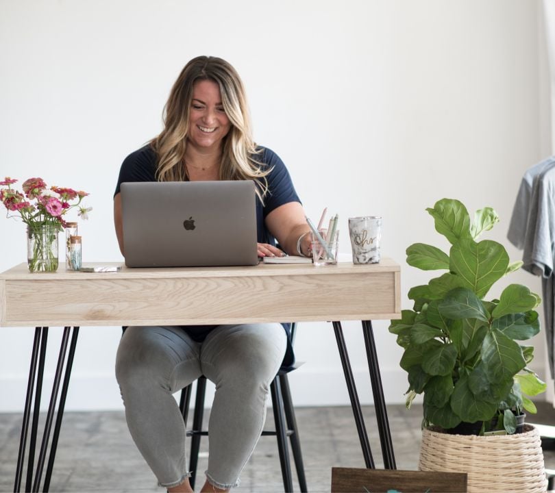 Alissa Bankowski, product design lead at Evive, cheerily works at her desk.