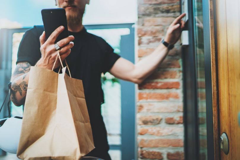 A deliveryman verifying the recipient of his order