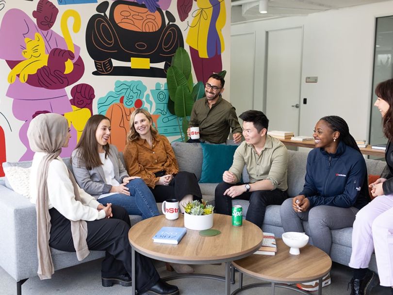 InStriders share a laugh around a communal couch.