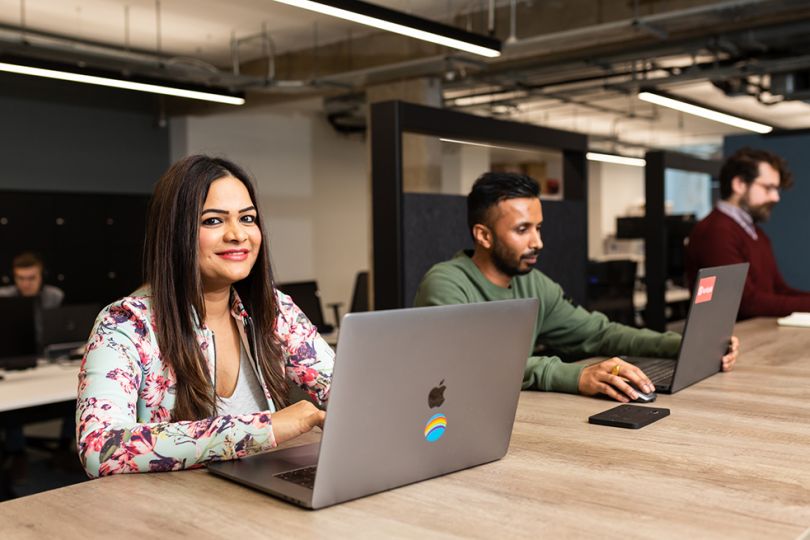 Indeed Flex team members working on laptops in the office
