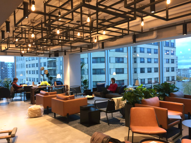 A modern office with sleek furniture and large windows