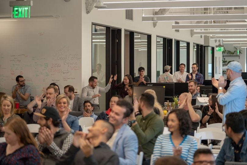 Infillion team members at a staff meeting in the office