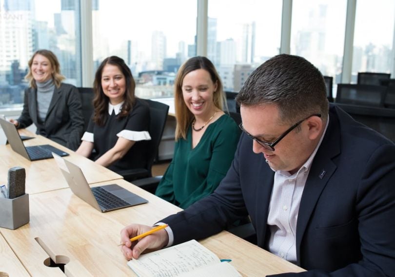 Inspirant Group leaders chatting at a conference table
