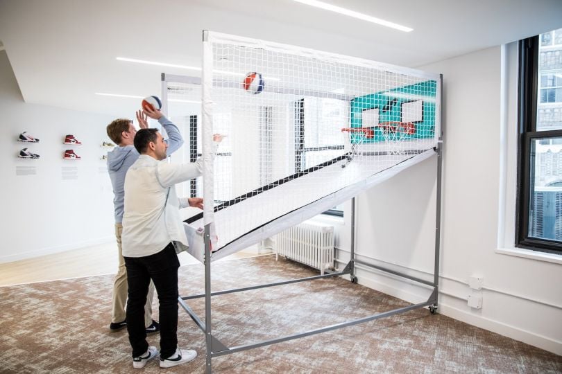 WSC Sports’ employees shoot hoops in the company’s new office.