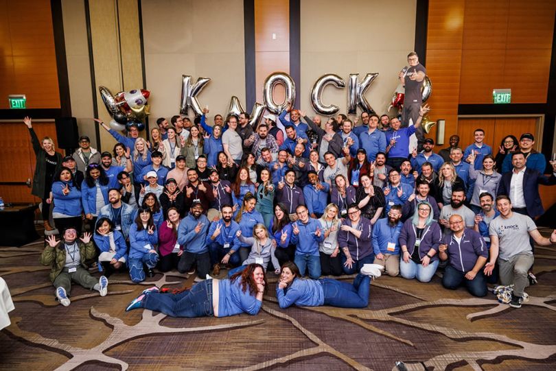 Knock team members with gold balloons that spell out KNOCK