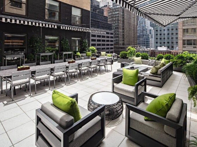 An image of an outdoor terrace at Leaf Home’s NYC office, which offers chairs and long tables for seating.&nbsp;
