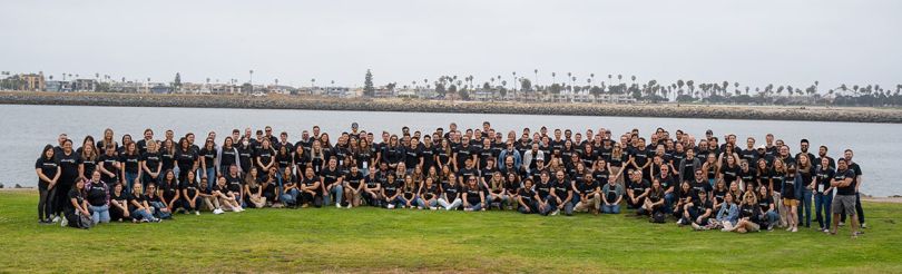 Lever group photo outside with a lake behind them