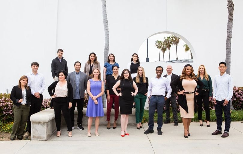 Lightyear Health team photo outside with palm trees in the background