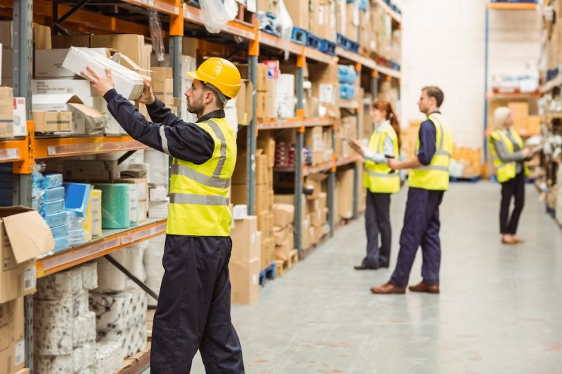 Man in safety gear working in warehouse