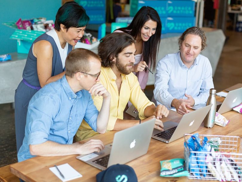 SnackNation employees collaborate in the office