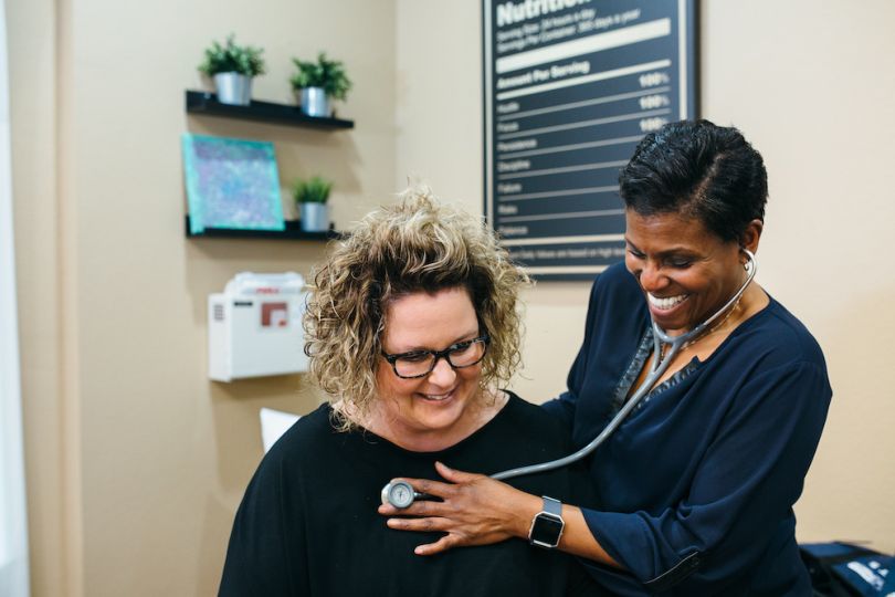 A doctor checks the pulse of one of her patients.
