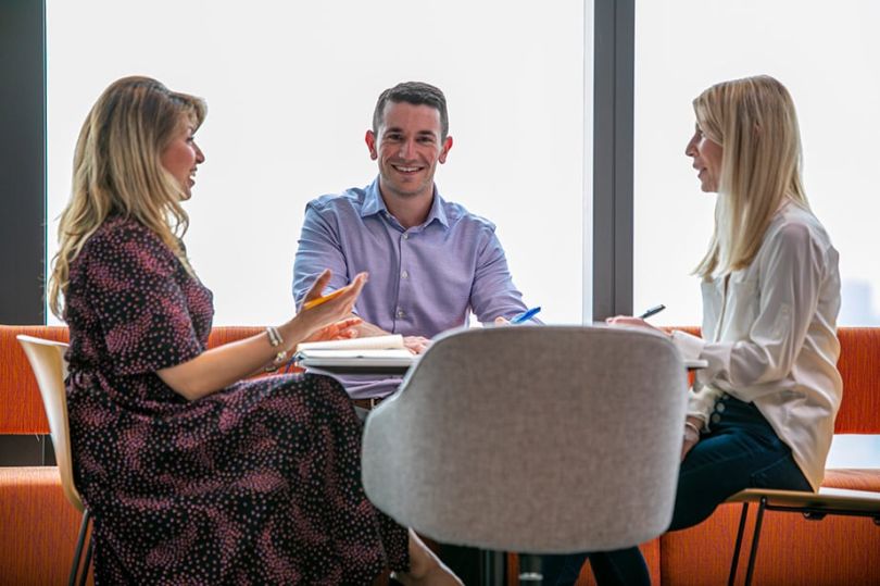 MarketAxess colleagues having a team huddle in the office