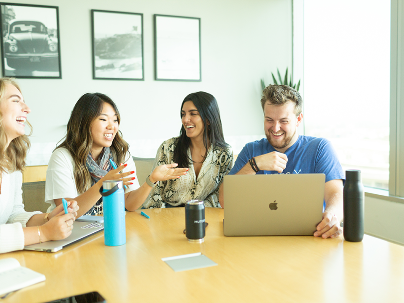 Alex Bocquet laughs with coworkers