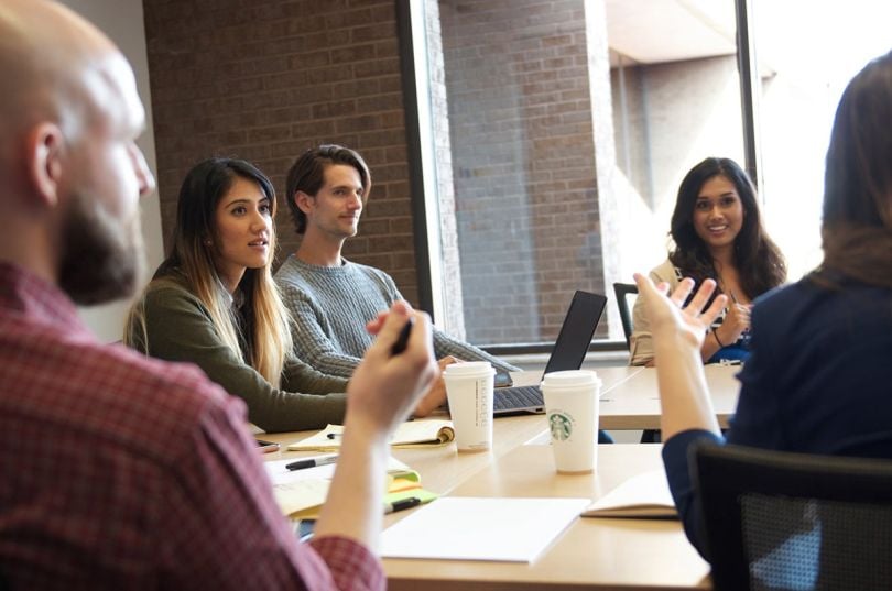McMaster-Carr team members sitting around a table in a conference room having a meeting