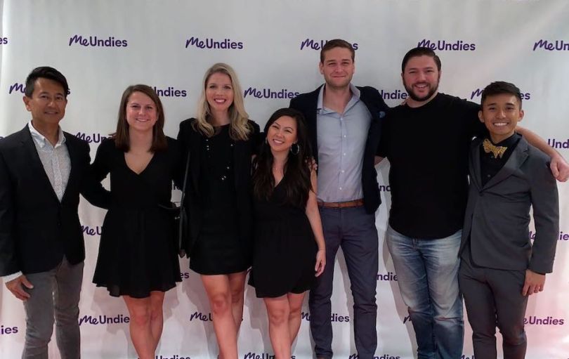 MeUndies team members posing at formal event