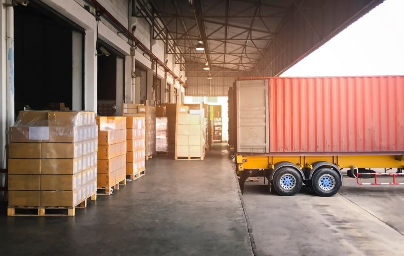 Trailer Truck Parked Loading Package Boxes at Dock Warehouse