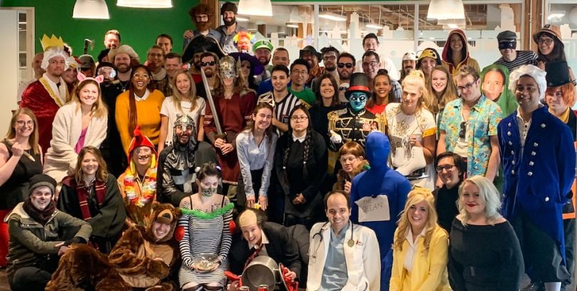 Neighborhoods.com staff posing during their Halloween party