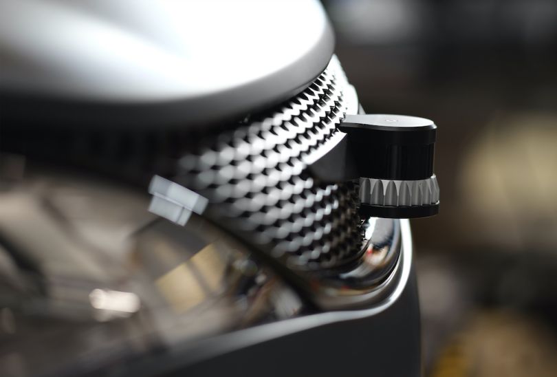 An Ouster LiDAR device is attached to the outside of a vehicle.
