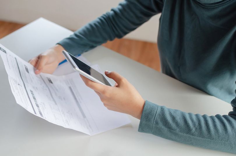 hands of young woman using mobile smart phone for scan and payment online