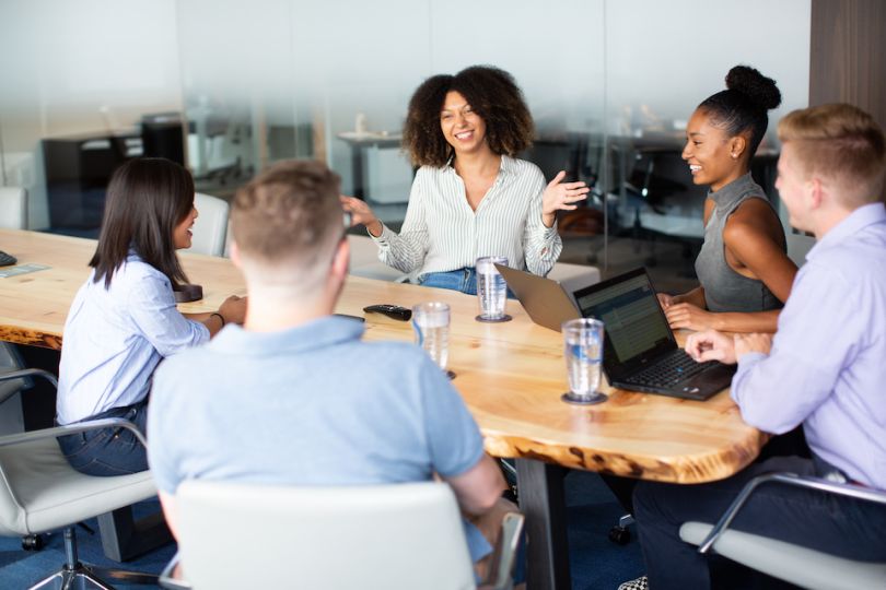 OppLoans team chatting in their office