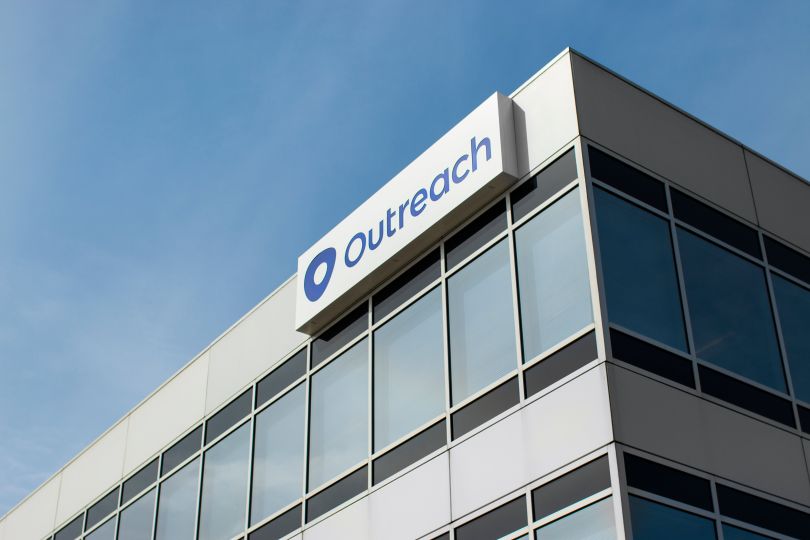 A shot of the top of Outreach’s office building with the logo visible.
