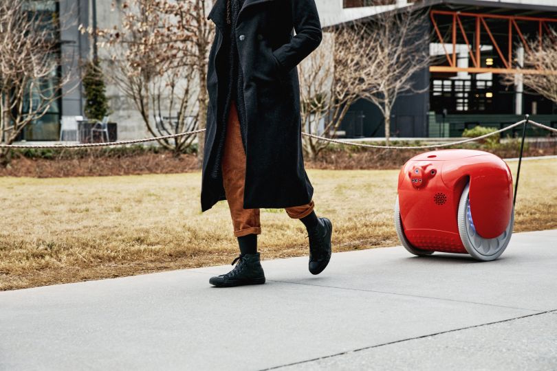 product stock photo of a red gita robot following a person