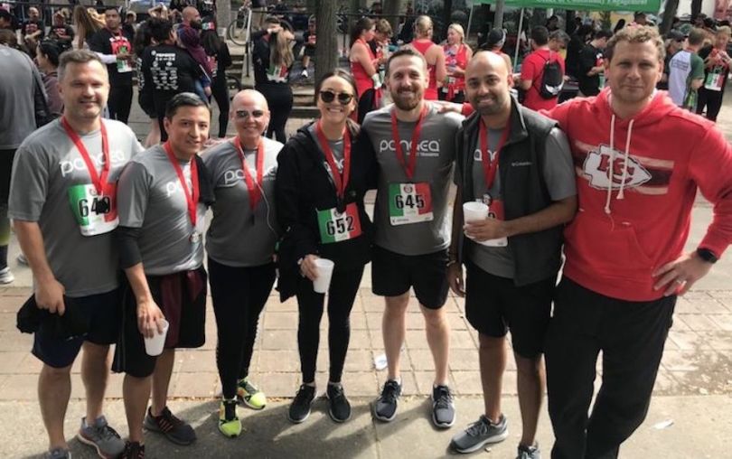 Pangea Money Transfer team members posing after running event